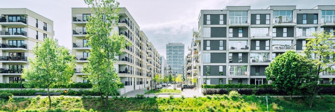 Blöcke mit Wohnhäusern in eriner Stadt am Kanal bei Sonnenschein