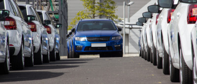 Parken in zweiter Reihe: Ist es immer verboten? Durch einen schmalen Weg aus hellen Autos fahren blaue Autos. Parken in zweiter Reihe: Ist es immer verboten? Durch einen schmalen Weg aus hellen Autos fahren blaue Autos.