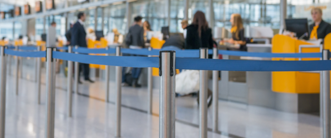 Fluggepäck: Nur bei ausdrücklichem Hinweis kostenfrei. Blaue Absperrbänder im Terminal eines Flughafens.