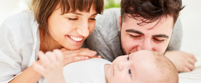 Eltern schauen glücklich ihr Baby an 