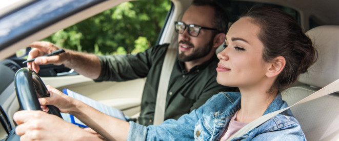 Mädchen mit Fahrschullehrer im Auto