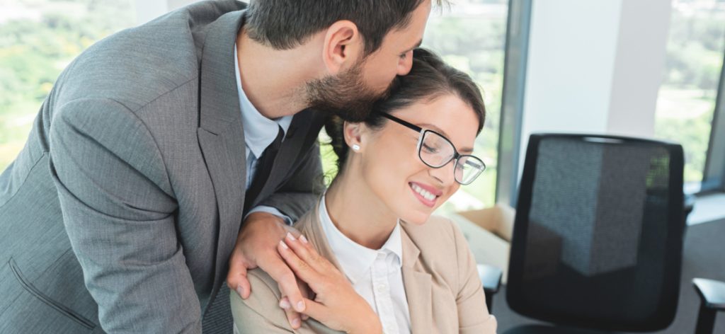 Business couple romancing at office